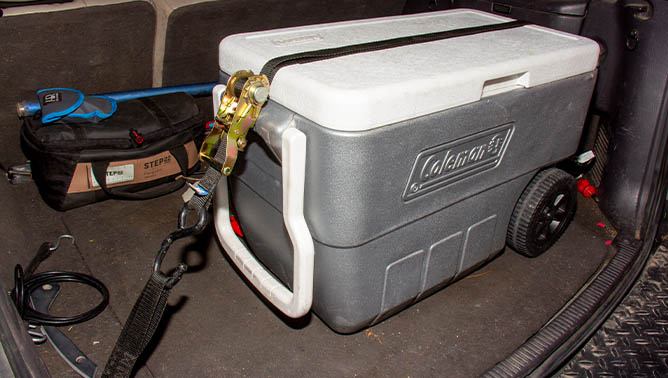 Mac's custom tie downs ratchet strap holding down cooler