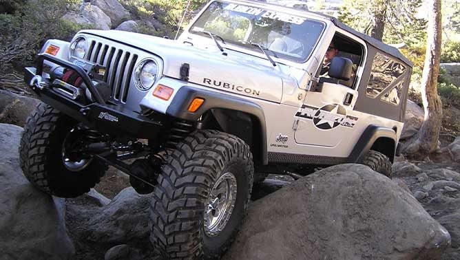 silver jeep rock crawling at rubicon