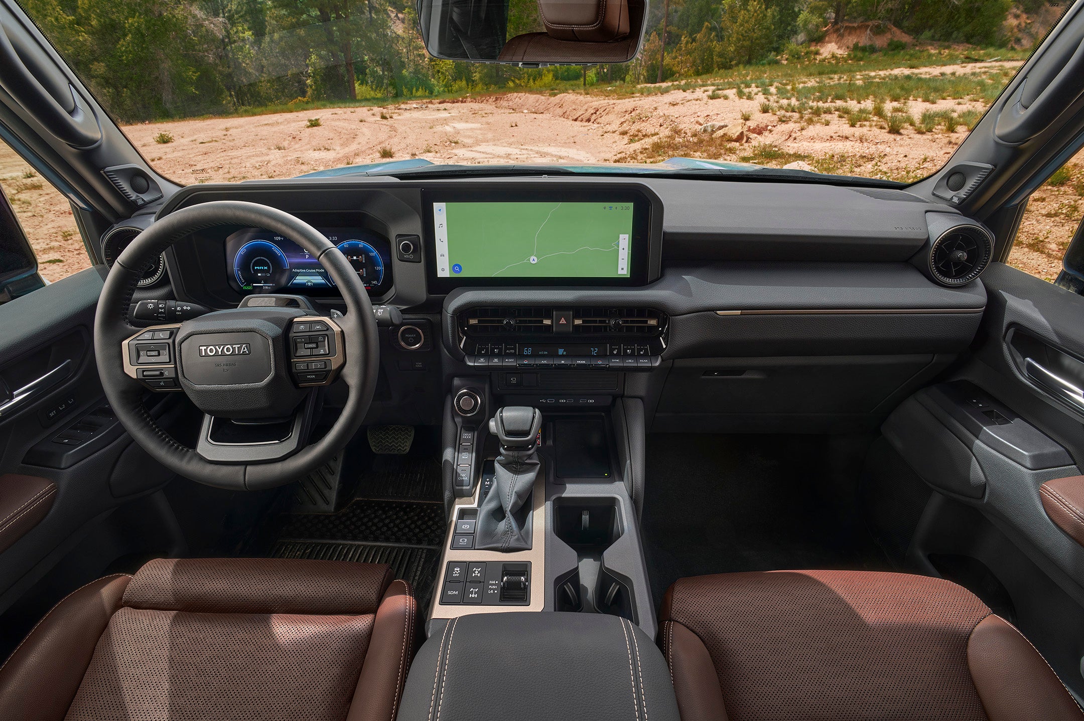 The Land Cruiser interior features seats trimmed in optional brown leather and a 12.3-inch touch screen.