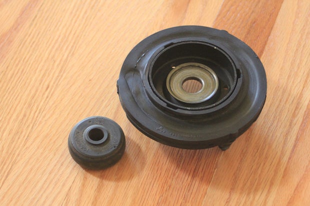 Speaking of Toyota, many folks miss that there's a formed washer pressed into the bottom of the top-hat. This is one of the two that bookend the lower bushing.