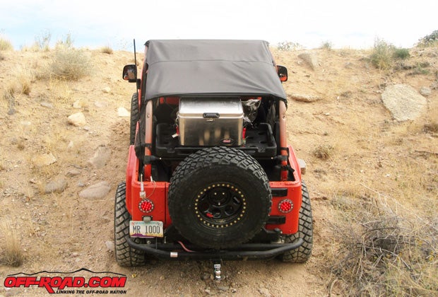 Bestops full-length Bikini top shades the Jeep from the windshield to the rear roll bar. Beneath the top, the Coleman ice chest leaves plenty of room in the rack.
