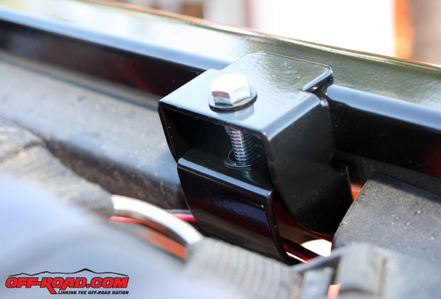 Align the header with the windshield and snap the J-hook brackets onto the clamp receptacles in the windshield frame.