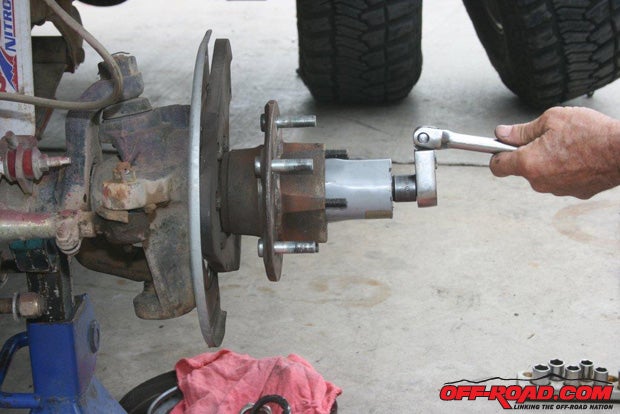 Using an axle nut socket, remove the axle nut.