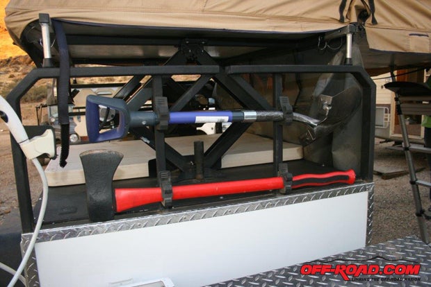 Above the toolbox is a mount for shovel and ax – it’s out of the way but easy to grab and use.