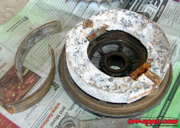 Its a good thing we took the rear wheel apart, because heres what greeted us: the shoes had come off of the backing and everything was coated in crud and rust.