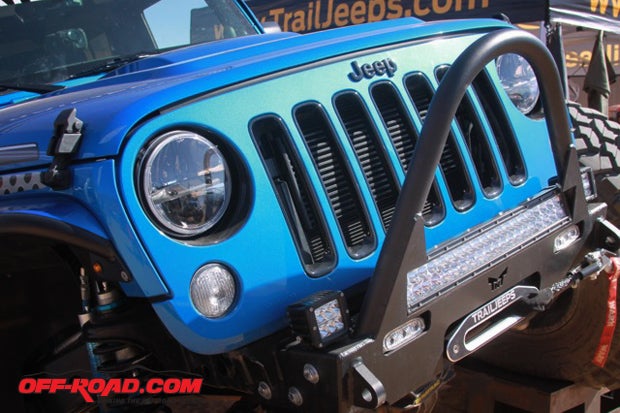 TNT Customs JK Guardian Front Bumper outfitted with LED lights and Warn winch sits at the front of the Trail Jeeps Polar JK. Truck-Lite LED headlights and clear turn signals frost the grill.
