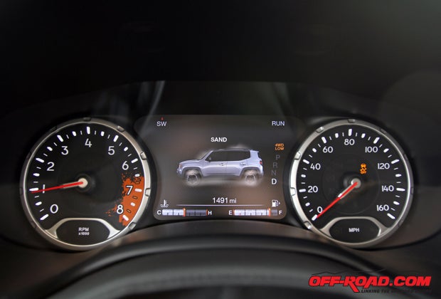 The full-color 7-inch instrumentation cluster on this Trailhawk version displays the terrain selected for off-road driving. The paint-splatter on the tachometer is just one example of the young-at-heart vibe that designers wanted to impart with this new Jeep.