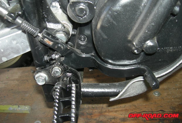 The rear brake was a complicated affair, and we had to remove the foot peg to get it on properly.