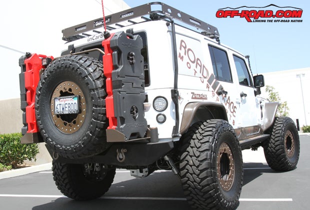 At the rear of the 2012 RRM Wrangler, a Poison Spyder RockBrawler Spare Tire Carrier hold the 37-inch spare Toyo tire. RRM fitted its RotoPax holders onto the mount, holding two 4-gallon fuel tanks and two RotoPax tool kits.