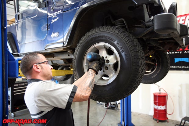 ORWs Lenny De Taranto gets the Wrangler ready by removing the stock 15-inch Jeep wheels and 31-inch BFGoodrich AT KO tires.