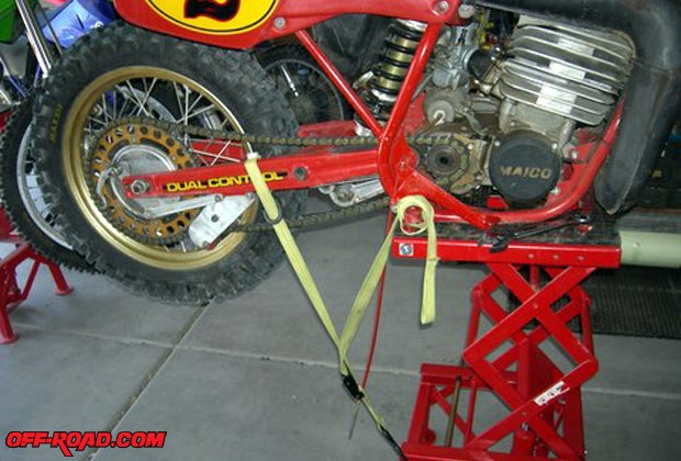 A tie down was used to prevent the bike from nose-diving on the elevated work stand.