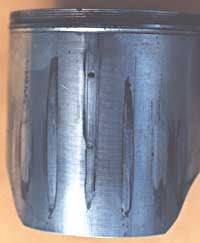 This piston has many vertical seizure marks;  more than likely the cylinder was bored to a diameter that was too small for the piston. As soon as the engine started and the piston started its thermal expansion, the piston pressed up against the cylinder walls and seized.