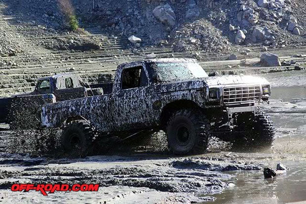 Mike Bishop, President of A.C.O.R.A., gives us a show in his early Ford 4x4--flinging mud in every which direction. 