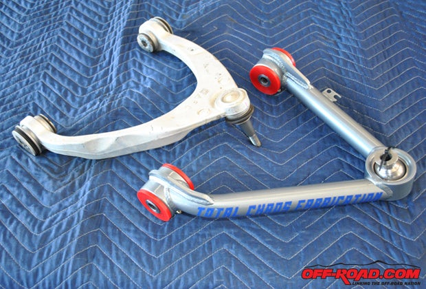 The stock control arm (left) will be replaced with the Total Chaos UCA not simply because the 4130 chromoly part is beefier and sturdier, but because it will allow up to 2 more inches of suspension travel so the truck can take advantage of the additional travel provided by the Fox coilovers.