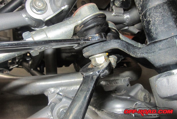 After removing cotter pin, then use your socket to remove the nut. This step could require you to hold the top of the tie rod end with a second wrench. 