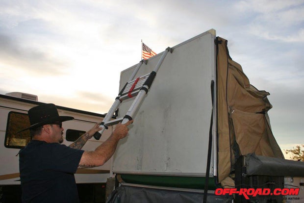 Grab the adjustable ladder and lift the tent’s floor up and then drop it into position.