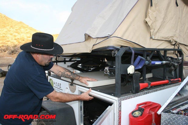 This Fort is equipped with the optional 12-volt tent lift system ($798), which has two rocker switches in the storage box for up and down operation. There is a door on each side of the storage box for access. Inside is the 18-gallon water tank and over 19 cubic feet of secure weather-proof storage.