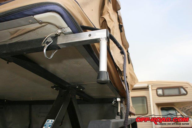 Once the tent platform is high enough, extend the support legs, re-pin them, and lower the legs down onto the safety rails. The safety rails protect the tent in case a condition of upset occurs; much like your Jeep’s roll bar protects you.