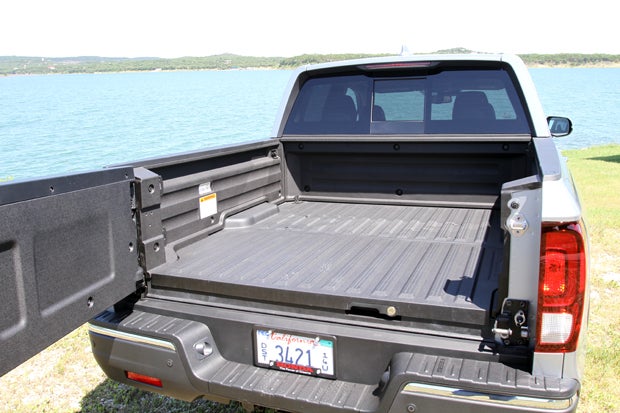 The unique bed on the Ridgeline may not be as deep as others but it also has no wheel well intrusion. It is 5'4" in length and features a dual-action tailgate that folds down and swings out (shown). 