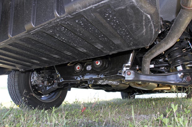No spare here: Here's a look at the multi-link rear suspension of the Ridgeline and the underside of the in-bed trunk.