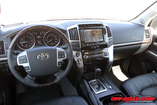 The interior of the fifth-generation Land Cruiser features wood trim accents and leather seats throughout. 