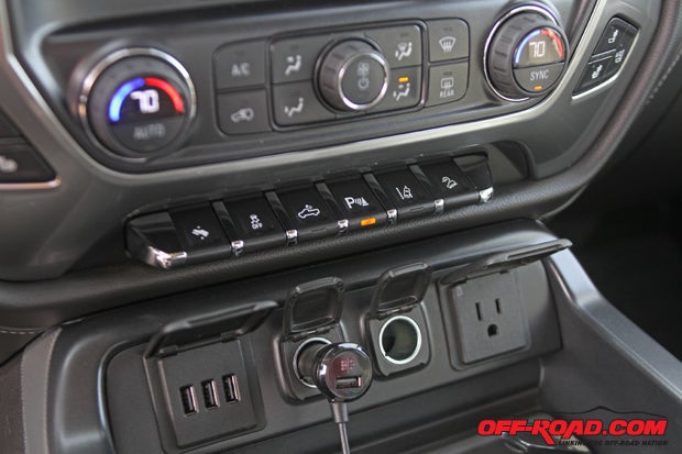 The piano key function bar below the HVAC is a nice feature - its easy to find and easy to use. It controls functions like Downhill Assist Control, traction control, parking sensors and more. Just below it the USB and 12-volt power outlets are visible in the center console storage.