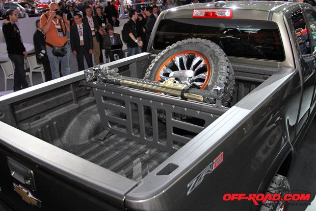 A full-sized spare tire sits in the truck bed, while Chevy utilized its GearOn bed divider to separate bed storage space and house the Hi-Lift jack. 