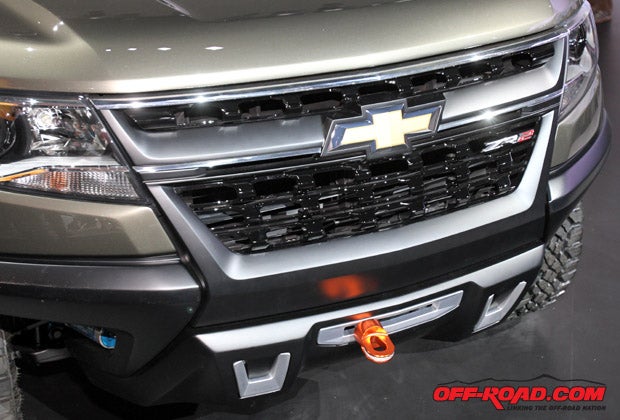 The customized front grill thoughtfully incorporates a recovery winch into its design. 